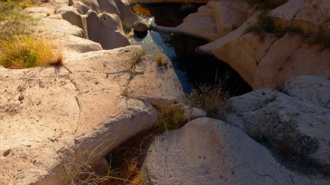 Canyon surrounded by rock formations. Stock Footage 88368975