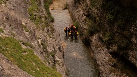 Canyoning walking down a river – medium shot Stock Footage 98292904