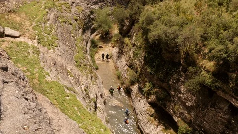 Canyoning walking down a river – wide shot Stock Footage 98291914