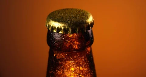 Cap of beer bottle rotating in slow motion. Extreme close up view, shot on RED Stock Footage 107527061