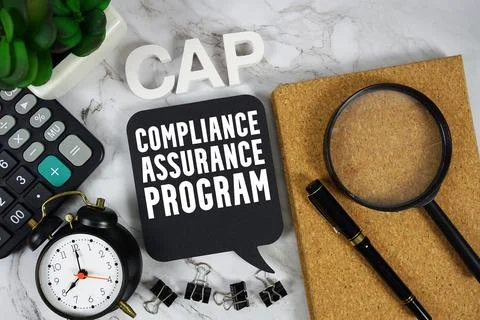 CAP Compliance Assurance Program text with Calculator, alarm clock and magn.. Stock Photos