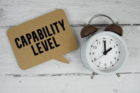 Capability Level text with alarm clock on wooden background Stock Photos