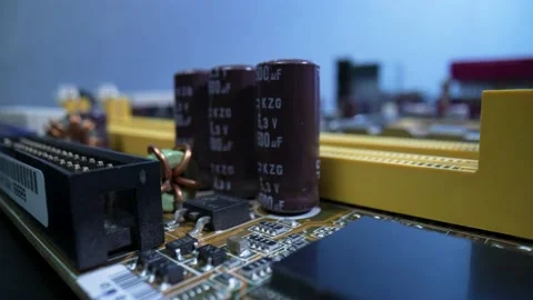 Capacitors, induction coils, chips and memory slots on a computer motherboard Stock Footage 182388575