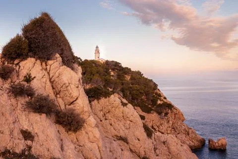 Capdepera lighthouse, sunset with soft light,bay with rocks and trees, , Cala Stock Photos