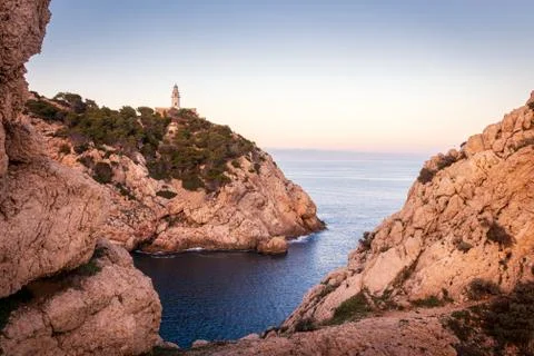 Capdepera lighthouse, sunset with soft light,bay with rocks and trees, , Cala Stock Photos
