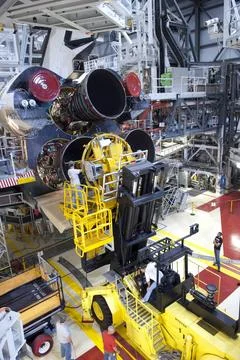 CAPE CANAVERAL, Fla. -- Technicians guide the specialized engine installer... Stock Photos