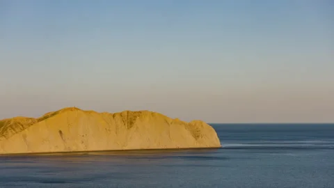 Cape Chameleon in the light of the setting sun and at dusk. Black Sea, Crimea. Stock Footage 155249722