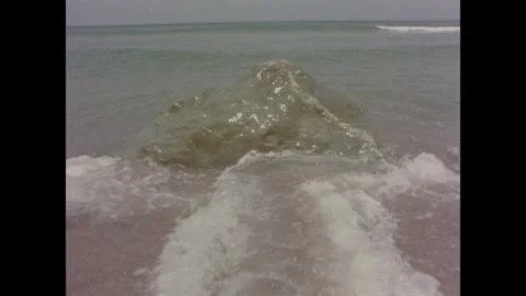 Cape Cod 1970s: Coastal scenery featuring waves crashing on a rocky beach, a Stock Footage 331224673