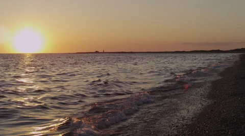 Cape Cod beach with waves, sunset, and lighthouse 1 Video stock 39884747