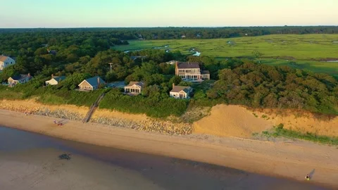 Cape Cod Drone Golden Hour Over Beachfront Houses and Low Tide Tidal Channels 動画素材 325781538