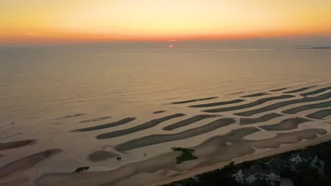 Cape Cod Drone Sunset Over Beach Houses and Tidal Sandbars With Glimmering Sun Stock Footage 325781668