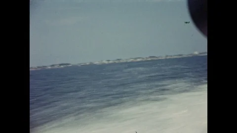 Cape Cod, Massachusetts 1940s: Tourists enjoy a speedboat ride across an ocean Video stock 106626194