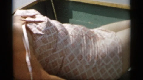 CAPE COD MASSACHUSETTS-1956: Lady Laying Down On A Boat In A Light Purple Dress Vídeos de archivo 125304292