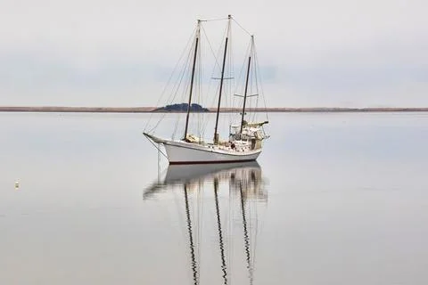 Cape Cod Sailboat and Reflection Stock Photos