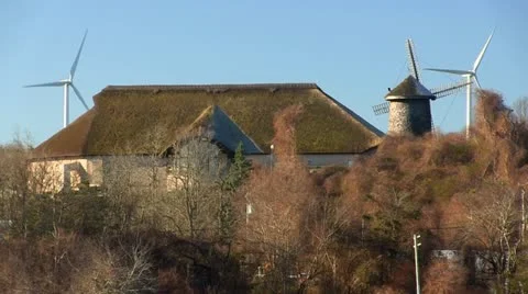 Cape cod thatched roof building, wind mills &amp; turbines Stock Footage 10881447
