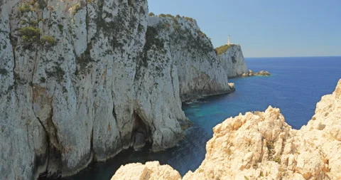 Cape Doukato cliffs ending with the lighthouse entering the Medietrranean sea Stock Footage 298931291