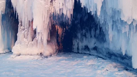 Cape with ice and icicles on winter Baikal lake at sunset Stock Footage 219955441