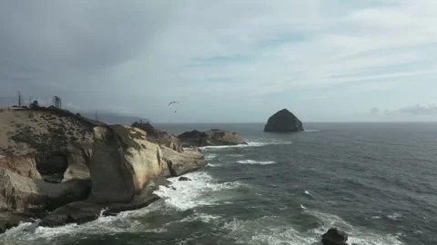 Cape Kiwanda shore with stormy waves and paraglider above coast, Oregon Stock Footage 273783312