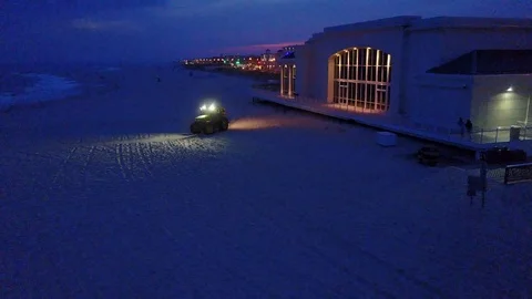 Cape May beach sweeper at sunset Stock Footage 99048615