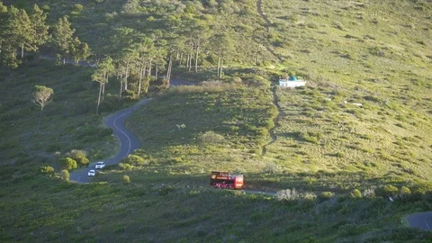 Cape Town winding road to Signal Hill summit with red tour bus Stock Footage