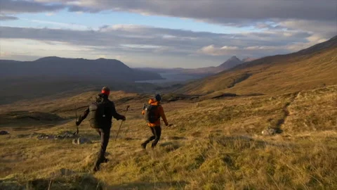 Cape Wrath Trail, UK - 5 September 2018 - 2 people are running in the mountains Stock Footage 140106342