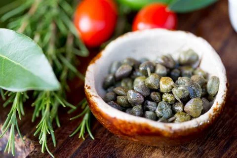 Capers and herbs. Selective focus Stock Photos