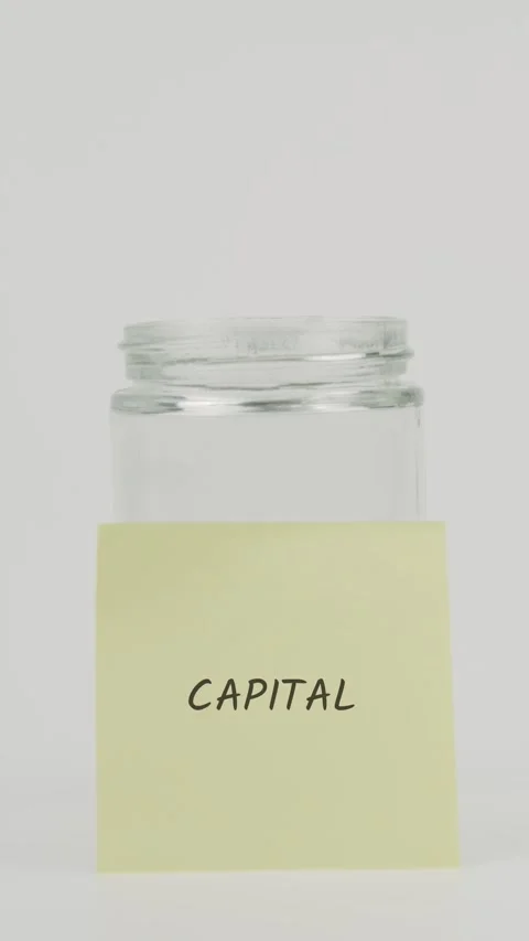 Capital text or word on yellow sticky note attached to glass jar with hand Stock Footage 311687639