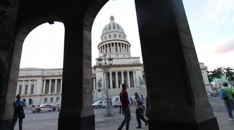 Capitol Building in B/G, young man walks in front, Old Havana Stock Footage 45521516