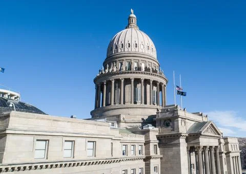 The Capitol building is a large, gray structure with a dome on top Stock Photos