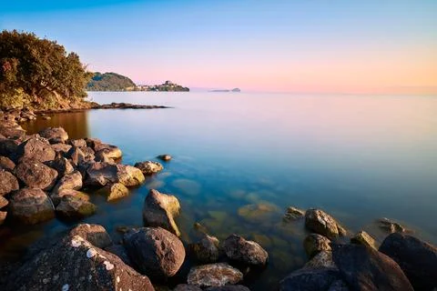 Capodimonte on Bolsena Lake at dawn and sunrise, long exposure with rocks Stock Photos