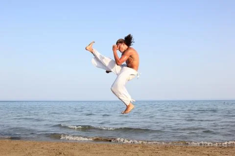 Capoeira dancer on the beach Stock Photos