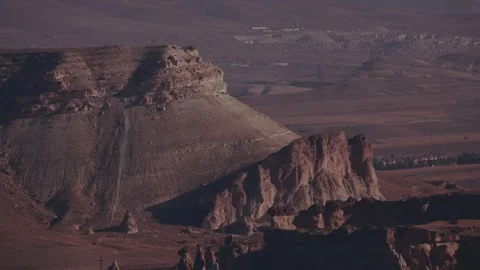 Cappadocia landscape shows rock formations and distant towns in daytime Stock Footage 336806494