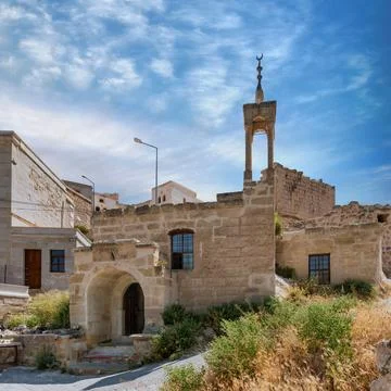 Cappadocia, Turkey: Stone architecture featuring Mosque near Cavus Castle, or Stock Photos