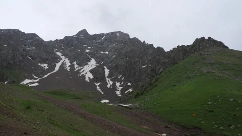 Capped mountain range against cloudy sky Stock Footage 295312509