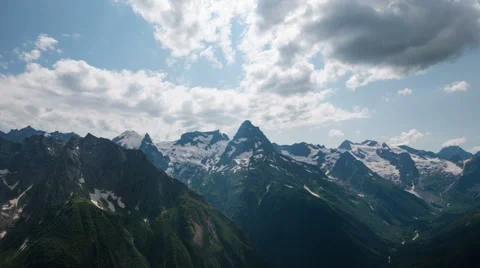 Capped mountains in the snow with alpine meadows Stock Footage 52350022