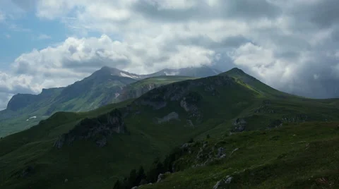 Capped mountains in the snow with alpine meadows Stock Footage 53103570