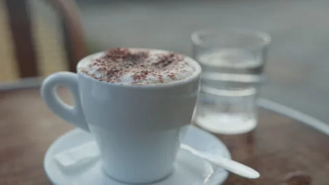 Cappuccino on Cafe Table at Sunset with City Bokeh in Paris France Stock Footage 323916449