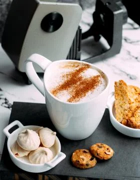Cappuccino with cinnamon and bisquits Stock Photos
