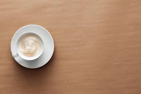 Cappuccino coffee on a brown empty background. View from above. Copy space Stock Photos