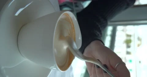 Cappuccino cup in front of window, vertical 4K Stock Footage 235356949