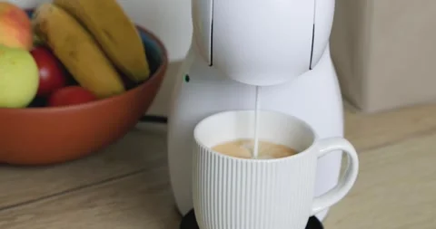 Cappuccino flows into the cup from the coffee machine Stock Footage 346451809