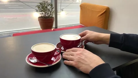 Cappuccino or latte in red ceramic cups for couple or friends. Coffee morning Stock Footage 231442392