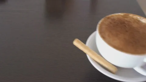Cappuccino placed on a table, man's hands, 4k Stock Footage 101895297