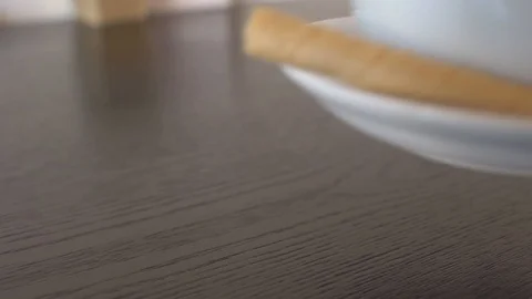 Cappuccino placed on a table, woman's hands, 4k Stock Footage 101895310