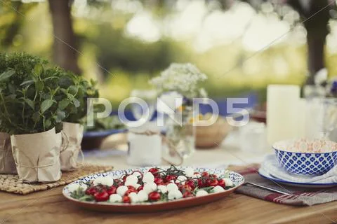 Caprese salad appetizer on patio table Stock Photos