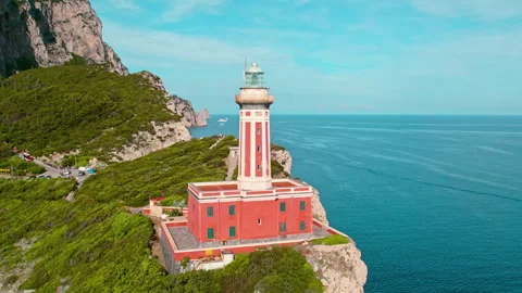 Capri coastline with lighthouse on rocky cliffs with green pine tree forest Stock Footage 264897686