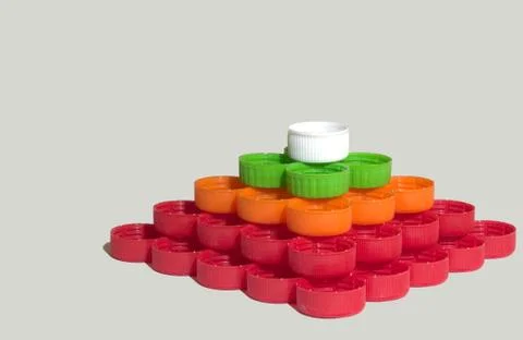 Caps of plastic bottles, collected in quadrangular pyramid Stock Photos