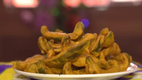 Capsicum Pakodas Rotating Turntable SIdeview 4K Video stock 119317189