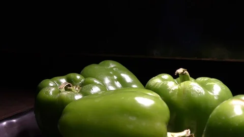 Capsicums in the dark moving in round circle Stock Footage 128200332