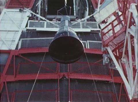 Capsule being hoisted up to Big Joe Atlas missile on launch pad facility Stock Footage 262445034